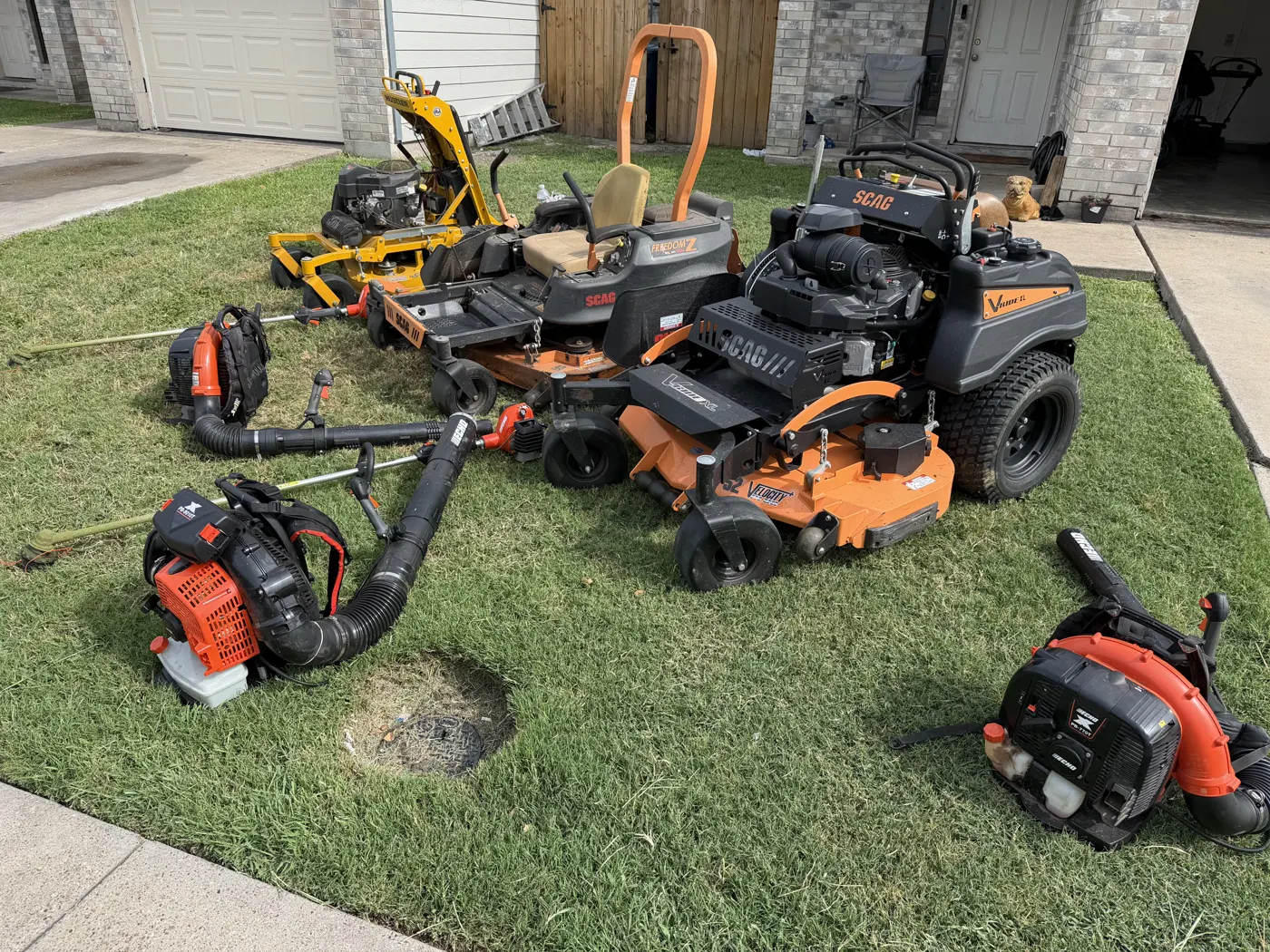 LRT's mowers, blowers and trimmers staged together on a fresh-cut lawn
