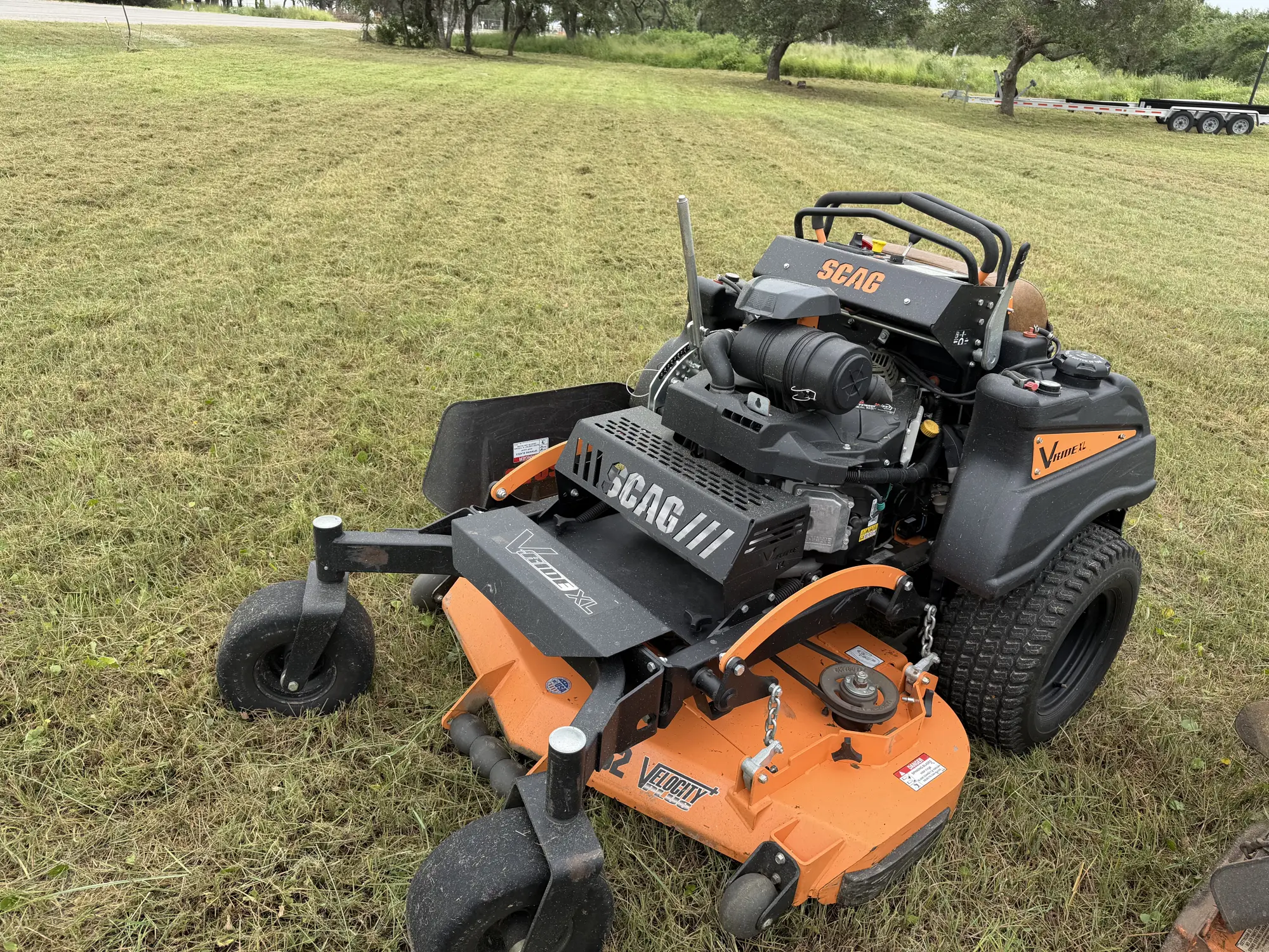 A SCAG zero-turn mower on a freshly cut open field