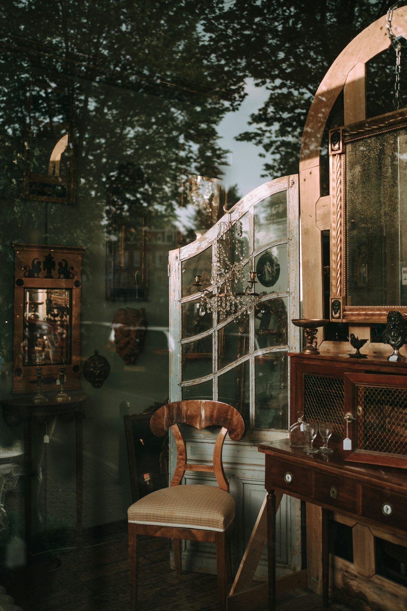 Antique furniture and mirrors in warm light